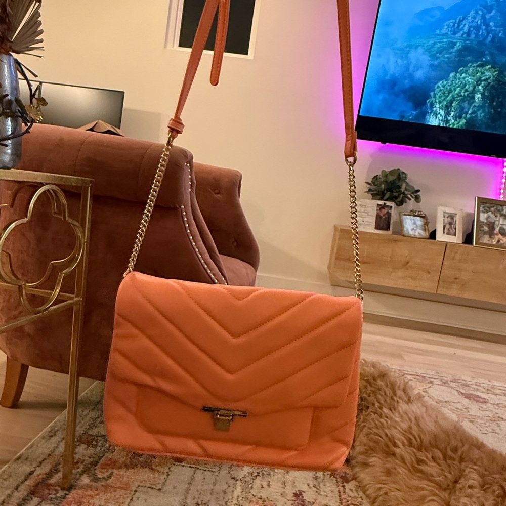 Vibrant Orange Crossbody Bag with Chevron Pattern and Chain Strap
